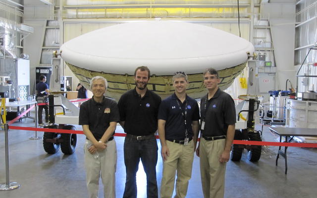 Members of the team for NASA's Low-Density Supersonic Decelerator (LDSD) stand in front of the project's saucer-shaped test vehicle at the U.S. Navy's Pacific Missile Range Facility in Kauai, Hawaii.