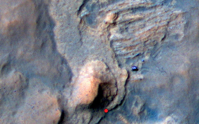 In this Mars Reconnaissance Orbiter view of the Curiosity rover mission's waypoint called "the Kimberley," the red dot indicates the location of a sandstone target, "Windjana," selected for close-up inspection. The