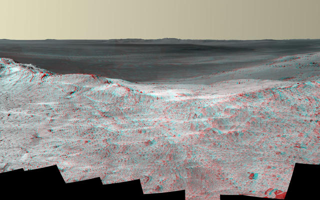This stereo vista from the panoramic camera (Pancam) on NASA's Mars Exploration Rover Opportunity catches "Pillinger Point," on the western rim of Endeavour Crater, in the foreground. The May 14, 2014, image appears three-dimensional when seen through blue-red glasses with the red lens on the left.