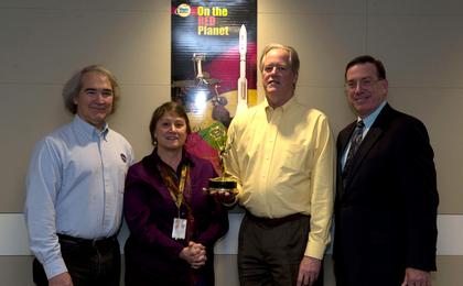 NASA Mars Exploration Program and NASM contributors pose with the Emmy statue.