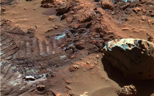 This false-color image highlights mysterious and sparkly dust-like material that is created when the soil in this region is disturbed.