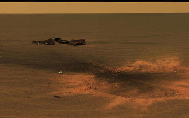This stunning image features the heat shield impact site of NASA's Mars Exploration Rover Opportunity.
