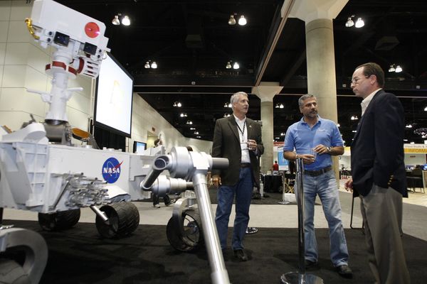 Doug McCuistion, Walid Abu-Hadba, and Roger Gibbs in the 'Big Room' at Microsoft's Professional Developers Conference, with a full-scale model of the Mars rover 'Curiosity,'scheduled to launch in 2011.