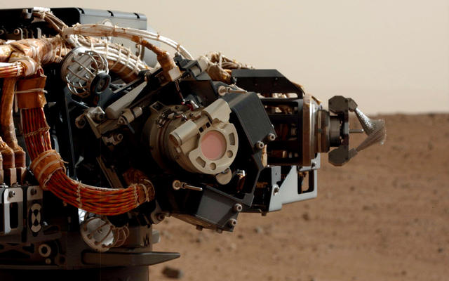 The left eye of the Mast Camera (Mastcam) on NASA's Mars rover Curiosity took this image of the camera on the rover's arm, the Mars Hand Lens Imager (MAHLI), during the 30th Martian day, or sol, of the rover's mission on Mars (Sept. 5, 2012).