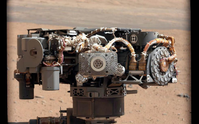 This image shows the Alpha Particle X-Ray Spectrometer (APXS) on NASA's Curiosity rover, with the Martian landscape in the background.