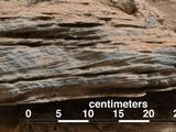 Cross-bedding seen in the layers of this Martian rock is evidence of movement of water recorded by waves or ripples of loose sediment the water passed over.