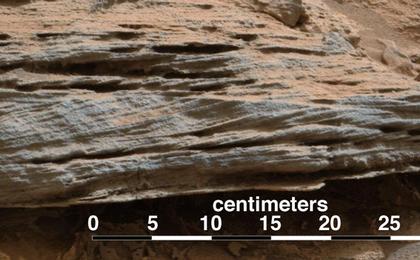 Cross-bedding seen in the layers of this Martian rock is evidence of movement of water recorded by waves or ripples of loose sediment the water passed over.