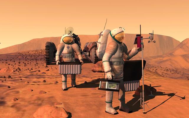 Two astronauts carry equipment to set up a weather station on Mars.