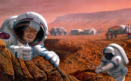 Two astronauts study a rock formation on Mars.  One is seen chipping away at a rock.  Two vehicles and an outpost are seen in the background.