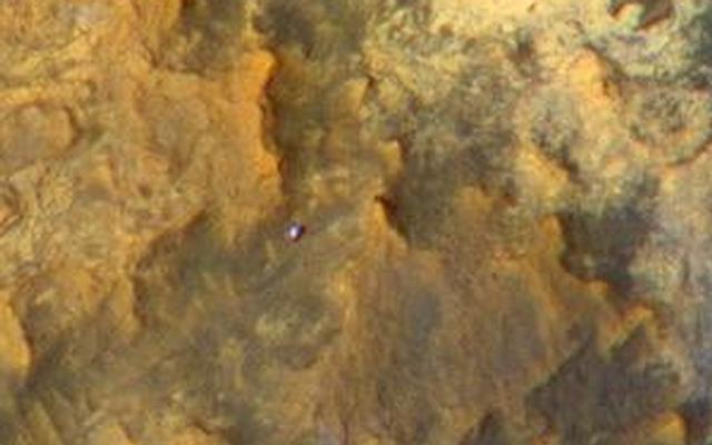 A view from NASA's Mars Reconnaissance Orbiter on April 8, 2015, catches sight of NASA's Curiosity Mars rover passing through a valley called "Artist's Drive" on the lower slope of Mount Sharp.