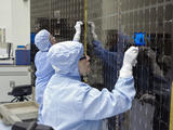 Inside Kennedy's Payload Hazardous Servicing Facility technicians clean the electricity-producing solar arrays for the Mars Atmosphere and Volatile Evolution (MAVEN) spacecraft Aug. 28.