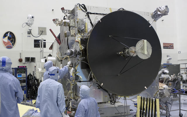 Engineers work on the MAVEN spacecraft, which is dominated by the high-gain antenna that is crucial to communications with NASA's Deep Space Network.