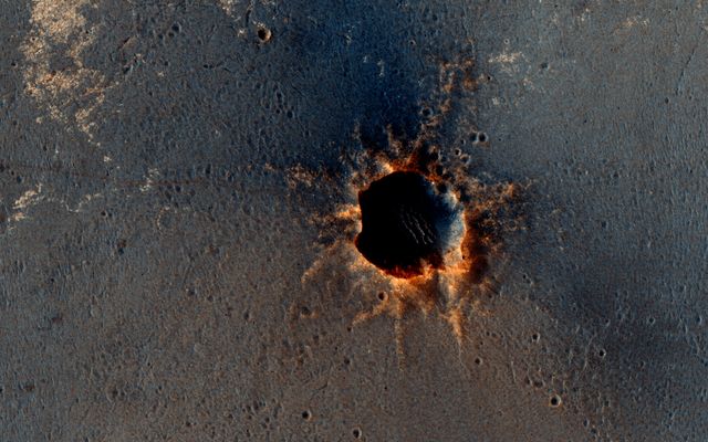 The High Resolution Imaging Science Experiment (HiRISE) camera on NASA's Mars Reconnaissance Orbiter acquired this color image on March 9, 2011, of &quot;Santa Maria&quot; crater, showing NASA's Mars Exploration Rover Opportunity perched on the southeast rim.