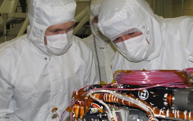 Grad student Nicholas Boyd (left) and Principal Investigator Ralf Gellert, both of the University of Guelph, Ontario, Canada, prepare for the installation of the Alpha Particle X-ray Spectrometer sensor head during testing at NASA's Jet Propulsion Laboratory.