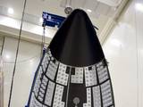 In the Payload Hazardous Servicing Facility at NASA's Kennedy Space Center in Florida, a section of the Atlas V payload fairing for NASA's Mars Science Laboratory (MSL) mission hangs vertically from the ceiling.