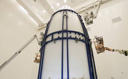 In the Payload Hazardous Servicing Facility at NASA's Kennedy Space Center in Florida, spacecraft technicians secure an Atlas V rocket payload fairing around NASA's Mars Science Laboratory (MSL).