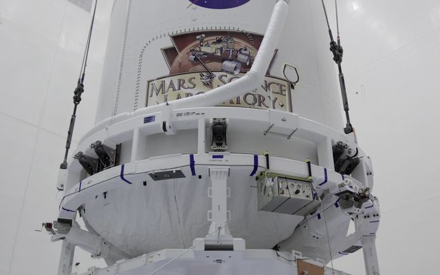 The Atlas V payload fairing containing NASA's Mars Science Laboratory (MSL) spacecraft rises above the floor of the Payload Hazardous Servicing Facility at Kennedy Space Center in Florida.