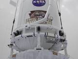 The Atlas V payload fairing containing NASA's Mars Science Laboratory (MSL) spacecraft rises above the floor of the Payload Hazardous Servicing Facility at Kennedy Space Center in Florida.
