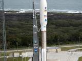 On Cape Canaveral Air Force Station in Florida, the 197-foot-tall United Launch Alliance Atlas V rocket arrives on the launch pad at Space Launch Complex-41, situated near the Atlantic Ocean.