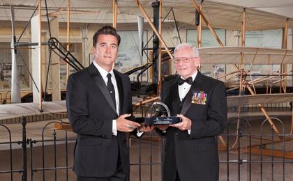 The leader of the entry, descent and landing team of NASA's Mars Science Laboratory project, Adam Steltzner of JPL (left), accepts the 2013 Trophy for Current Achievement from the Smithsonian National Air and Space Museum from museum director Gen. J. R. "Jack" Dailey on April 24, 2013.