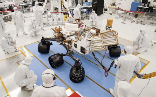 Technicians and engineers in clean-room garb monitor the first drive test of NASA's Mars Science Laboratory, also known as the Curiosity rover, on July 23, 2010.