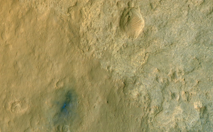 This color-enhanced view of NASA's Curiosity rover on the surface of Mars was taken by the High Resolution Imaging Science Experiment (HiRISE) on NASA's Mars Reconnaissance Orbiter as the satellite flew overhead.
