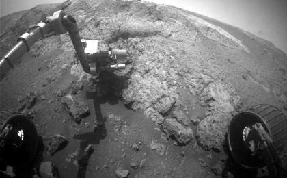 This image from the front hazard-avoidance camera (Hazcam) on the NASA Mars Exploration Rover Opportunity shows the rover's arm extended for examination of a target called "Onaping" at the base of an outcrop called "Copper Cliff" in the Matijevic Hill area of the west rim of Endeavour Crater.
