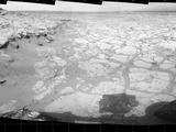 In a shallow depression called "Yellowknife Bay," the NASA Mars rover Curiosity drove to an edge of the feature during the 130th Martian day, or sol, of the mission (Dec. 17, 2012) and used its Navigation Camera to record this view of the ledge at the margin and a view across the "bay."