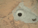 At the center of this image from NASA's Curiosity rover is the hole in a rock called "John Klein" where the rover conducted its first sample drilling on Mars.