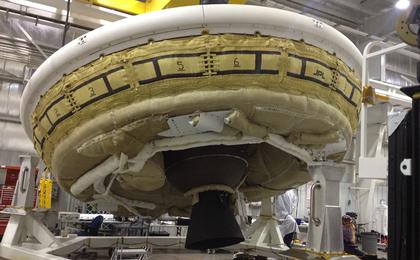 A saucer-shaped test vehicle holding equipment for landing large payloads on Mars is shown in the Missile Assembly Building at the US Navy's Pacific Missile Range Facility in Kaua'i, Hawaii.