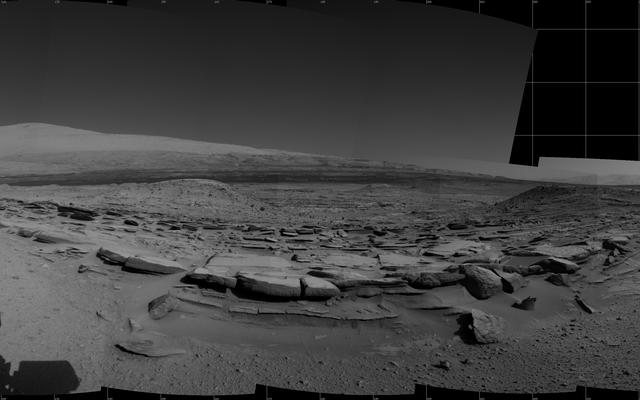 This view from NASA's Curiosity Mars rover spans 360 degrees, centered southward toward a planned science waypoint at "the Kimberley," with an outcrop of eroded sandstone in the foreground. It combines several frames taken by the Navigation Camera on March 18, 2014.