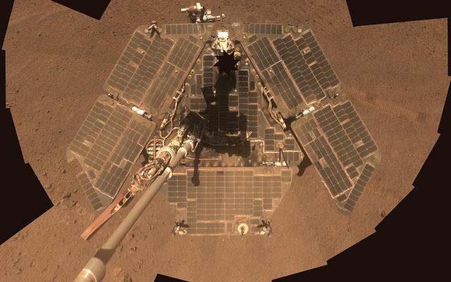 A self-portrait shows a view of the rover solar panels, which appear brown and dusty from overhead.