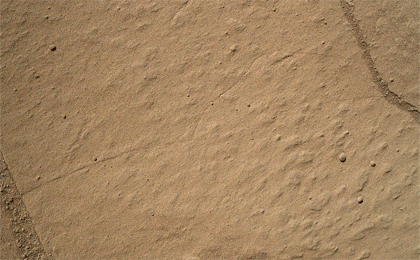 This two-step animation shows before and after views of a patch of sandstone scrubbed with the Dust Removal Tool, a wire-bristle brush, on NASA's Curiosity Mars rover.