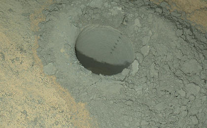 The Mars Hand Lens Imager on NASA's Curiosity Mars rover provided this nighttime view of a hole produced by the rover's drill and, inside the hole, a line of scars produced by the rover's rock-zapping laser.  The camera used its own white-light LEDs to illuminate the scene on May 13, 2014.