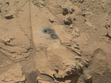 This May 12, 2014, view from the Mars Hand Lens Imager (MAHLI) in NASA's Curiosity Mars Rover shows the rock target "Windjana" and its immediate surroundings after inspection of the site by the rover by drilling and other activities.