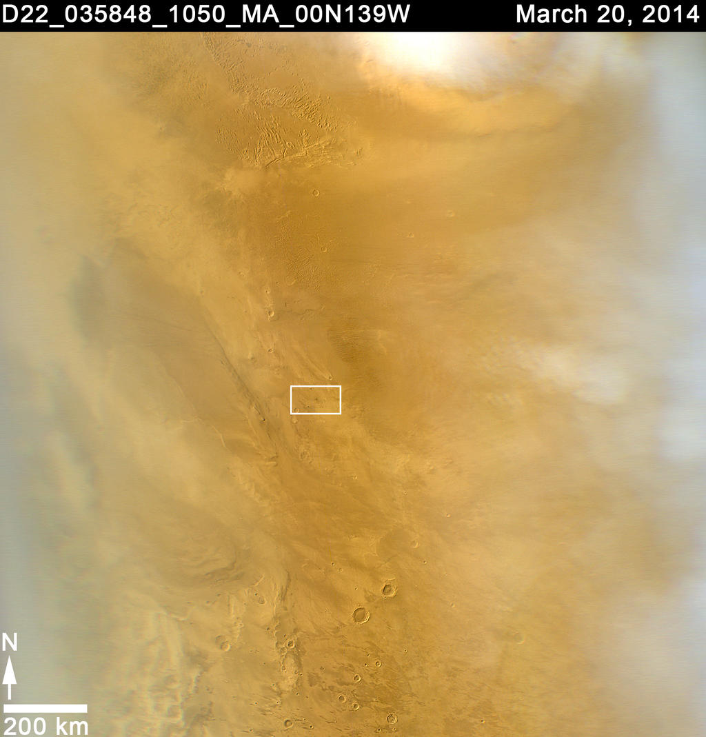 This March 20, 2014, image from the MARCI camera on NASA's Mars Reconnaissance Orbiter has a dark spot (at center of inscribed rectangle) noticed while the image was being examined for a weather report. Other observations confirmed that the spot is a scar from a space rock hitting Mars in 2012.