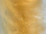This March 20, 2014, image from the MARCI camera on NASA's Mars Reconnaissance Orbiter has a dark spot (at center of inscribed rectangle) noticed while the image was being examined for a weather report. Other observations confirmed that the spot is a scar from a space rock hitting Mars in 2012.