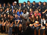 With students and NASA space shuttle astronaut Leland Melvin looking on, musical artist will.i.am posts a tweet soon after his song "Reach for the Stars" was beamed back from the Curiosity Mars rover and broadcast to a live audience at NASA's Jet Propulsion Laboratory in Pasadena, Calif.