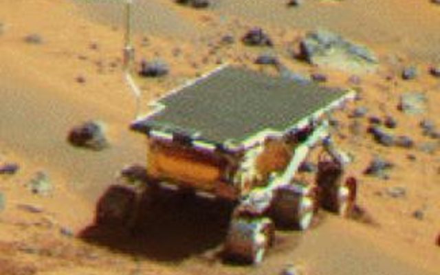 NASA's Mars Pathfinder Lander camera image of Sojourner Rover atop the 'Mermaid dune' on Sol 30. Note the dark material excavated by the rover wheels. Sol 1 began on July 4, 1997.
