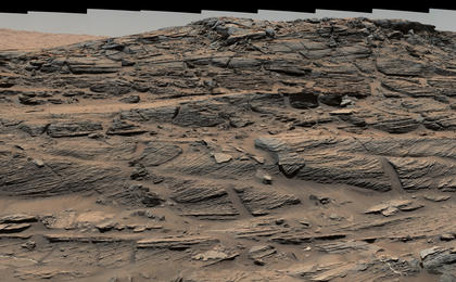 Large-scale crossbedding in the sandstone of this ridge on a lower slope of Mars' Mount Sharp is typical of windblown sand dunes that have petrified. NASA's Curiosity Mars rover used its Mastcam to capture this vista on Aug. 27, 2015. Similarly textured sandstone is common in the U.S. Southwest.
