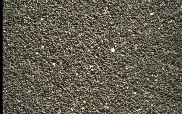 This Dec. 5, 2015, view of the undisturbed surface of a Martian sand dune called "High Dune" shows coarse grains remaining on the surface after wind removal of smaller particles. The image covers an area 1.4 inches across. It was taken by the rover's Mars Hand Lens Imager (MAHLI).