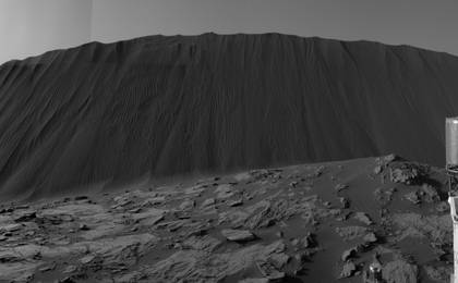 This view from NASA's Curiosity Mars Rover shows the downwind side of a dune about 13 feet high within the Bagnold Dunes field on Mars. The rover's Navigation Camera took the component images on Dec. 17, 2015. As on Earth, the downwind side of an active sand dune has a steep slope called a slip face.