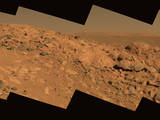This approximate true-color image taken by the Mars Exploration Rover Spirit shows a rock outcrop dubbed "Longhorn," and behind it, the sweeping plains of Gusev Crater.