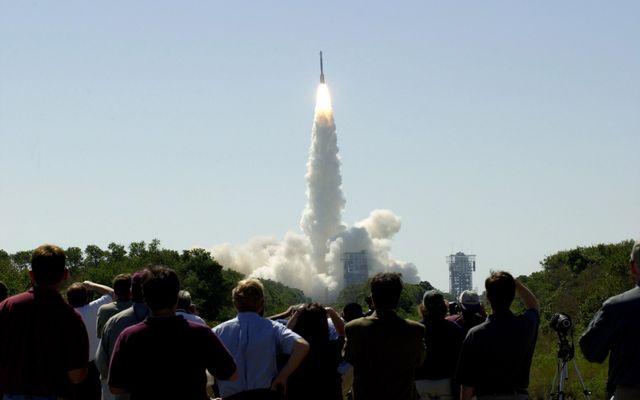 At 11:02 a.m. EDT on April 7, 2001, crowds watch a Boeing Delta II rocket lift off from Cape Canaveral Air Force Station, Florida, carrying NASA's 2001 Mars Odyssey spacecraft into space on its seven-month journey to Mars.