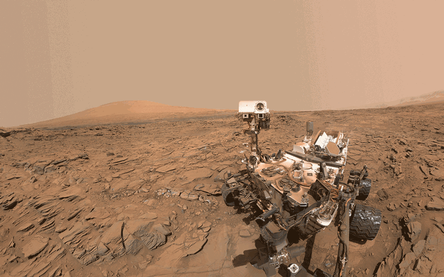 This animated image blinks two versions of a May 11, 2016, selfie of NASA's Curiosity Mars rover at a drilled sample site called "Okoruso." In one version, cameras atop the rover's mast face the arm-mounted camera taking the portrait. In the other, they face away.