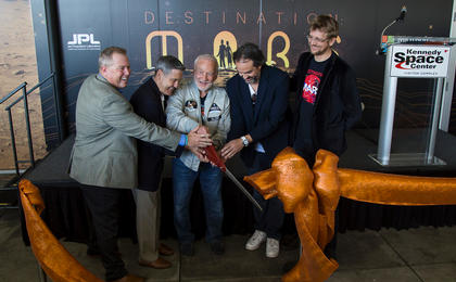 A ceremonial ribbon is cut for the opening of new "Destination: Mars" experience at the Kennedy Space Center visitor complex in Florida. From the left are Therrin Protze, chief operating officer of the visitor complex; center director Bob Cabana; Apollo 11 astronaut Buzz Aldrin; Kudo Tsunoda of Microsoft; and Jeff Norris of NASA's Jet Propulsion Laboratory in Pasadena, California.