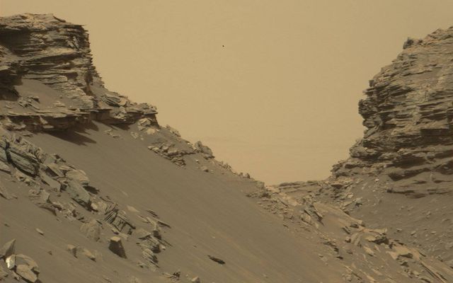 Curiosity viewed sloping buttes and layered outcrops as it exited the "Murray Buttes" region on lower Mount Sharp, Sept. 9, 2016.