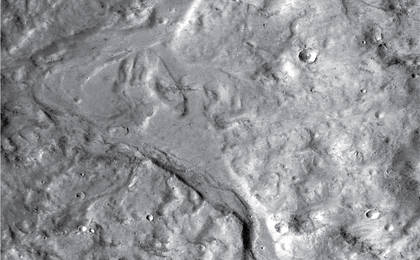 Streamlined forms in this Martian valley resulted from the outflow of a lake hundreds of millions years more recently than an era of Martian lakes previously confirmed. This image from the Context Camera on NASA's Mars Reconnaissance Orbiter covers an area in Arabia Terra about 8 miles wide.