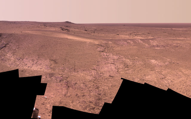 A grooved ridge called "Rocheport" on the rim of Mars' Endeavour Crater spans this scene from the Pancam on NASA's Mars rover Opportunity. The view extends from south-southeast on the left to north on the right. The site is near the southern end of an Endeavour rim segment called "Cape Tribulation."