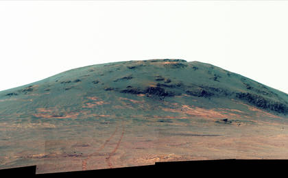 Wheel tracks from NASA's Mars rover Opportunity descending and departing the "Cape Tribulation" segment of Endeavour Crater's rim are visible in this April 21, 2017, view from the rover's Pancam. This version is presented in enhanced color to make differences in surface materials more visible.